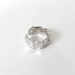 Detailed macro view of an irregular textured silver ring with lava surface and matte finish