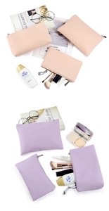 Pink and purple PU leather makeup bags shown with vanity accessories in a flat lay setup
