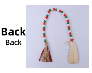 Detail view of the back of a Christmas wooden bead ornament with ribbon and tassel