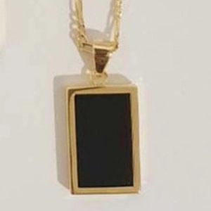 Detailed close-up of a 18k gold plated rectangular black shell pendant necklace