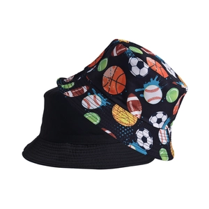 Detail of reversible bucket hat showing plain black side and multi-sport graffiti print