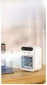 Close-up of a white mini portable air cooler with dual mist sprays on a wooden desk