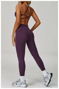 Detailed back view of dark purple yoga set featuring a cross-back sports bra and leggings