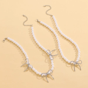 Three-strand faux pearl choker set with silver metal bowknot charms and adjustable clasp