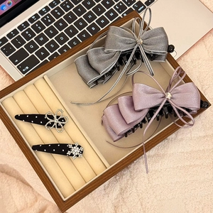 Elegant chiffon bow hair clips set with zircon stars and satin ribbons in a jewelry tray