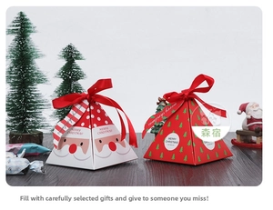 Pyramid-shaped Christmas gift boxes with Santa and tree patterns with red ribbon ties