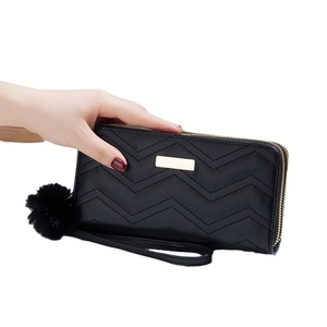 Elegant black quilted leather long wallet for women with zipper and fuzzy pompom charm