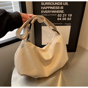 Close-up of off-white minimalist tote bag in soft nylon with stylish pleats and strap