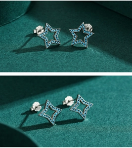 Macro shot of S925 sterling silver hollow star earrings featuring turquoise pavé stones
