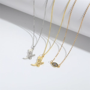 Minimalist evil eye and Christmas boot pendant necklaces in gold and silver finishes