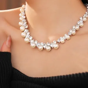 Elegant pearl and crystal necklace set worn by a model against a black knit backdrop