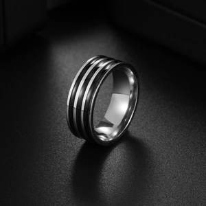 Detailed view of silver and black striped titanium steel ring with refined oily finish