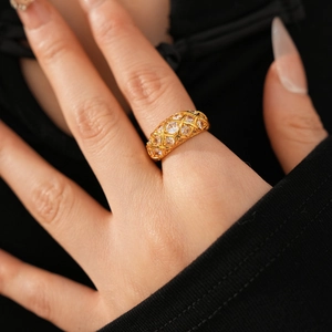 Macro detail of 24k gold plated flower ring with sparkling zircon in a wide mesh design