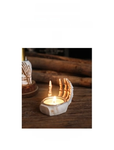 Detailed view of skull hand candle holder made of ivory white resin for Halloween decor