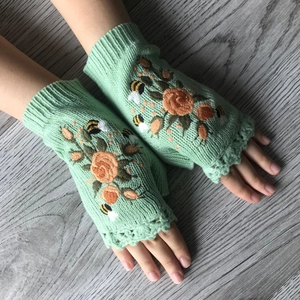 Mint green knitted fingerless gloves with elegant rose and bee embroidery detail