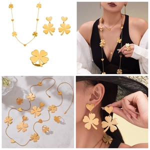 Detailed views of 18k gold plated clover jewelry set including necklace, earrings and ring