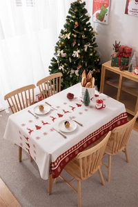 Detail of Christmas tablecloth with reindeer and snowflake print on high-quality fabric