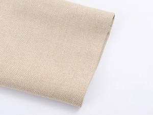 Detailed close-up of beige herringbone knit fabric for stylish long sleeve blazers