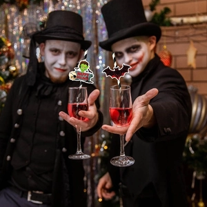 Detail of Halloween party straws with cartoon Frankenstein and bat toppers in party setting