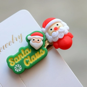 Macro shot of 3D Santa Claus hair clip with red hat on white jewelry card detail