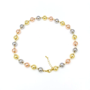 Detailed close-up of 18k gold, silver, and rose gold beads with a secure lobster clasp