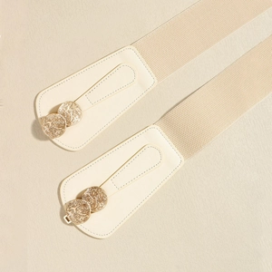 Close-up of beige elastic waist belt with gold double ring buckle and faux leather detail