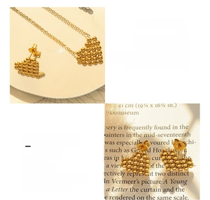 Detail of 18K gold-plated titanium steel heart necklace and matching stud earrings
