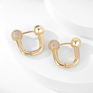 Elegant U-shaped gold earrings featuring a polished metal bead and a pavé zircon sphere
