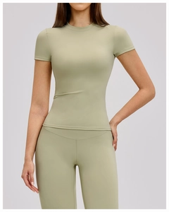 Detail of light sage green quick-dry yoga top featuring high-elastic breathable fabric