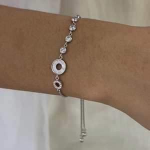 Adjustable silver bracelet featuring white shell inlay and zircon accents on wrist