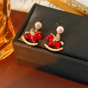 Detailed shot of red enamel horse earrings with white pearl and sparkling zircon stud