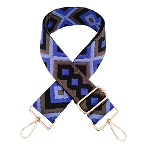 Close-up of diamond jacquard woven bag strap with golden metal swivel hooks and buckles