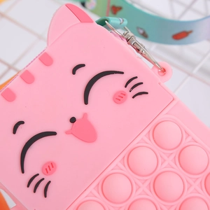 Detail view of pink silicone cat coin purse with colorful strap and pop-it bubble texture