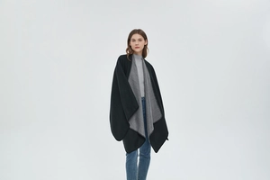 Detail of the soft black and grey reversible cashmere shawl with whipstitched edges