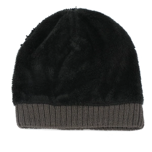 Detail of winter beanie showing thick black faux fur lining and knit texture