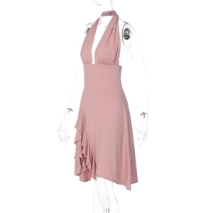 Detail view of pink halter neck dress with deep V-neck and ruffled asymmetrical hemline