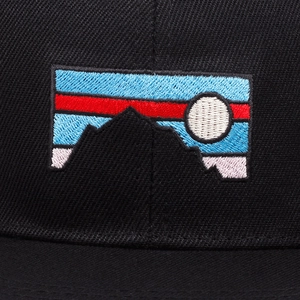 Black cotton baseball cap featuring embroidered mountain landscape logo in minimalist style