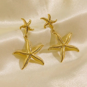 Elegant 14K gold plated double starfish drop earrings on luxury champagne silk fabric
