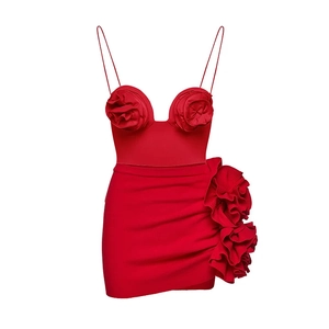 Detail of red two-piece set featuring 3D floral accents on crop top and mini skirt