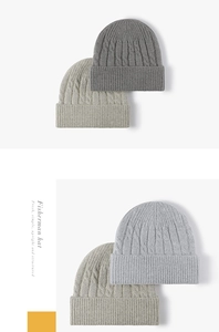 Detail of cable knit pattern and ribbed cuff on gray and beige winter beanies