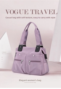 Detail of light purple nylon tote bag featuring front zip pockets and silver hardware