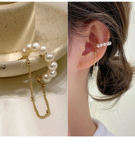 Macro detail of 14k gold plated pearl chain ear cuff with elegant fringe tassels
