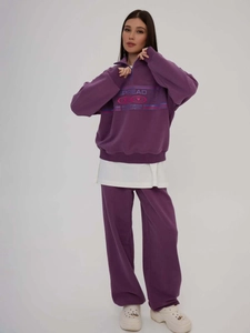 Purple two-piece lounge set with half-zip sweatshirt and wide-leg trousers for women