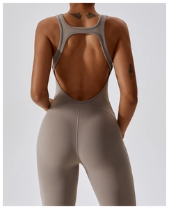 Rear view of moisture-wicking backless yoga jumpsuit with flattering flared leg fit