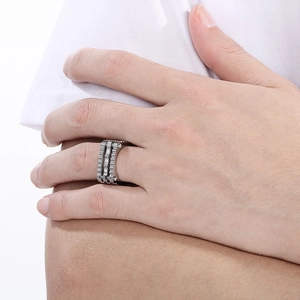 Detail of a punk style stainless steel gear ring with rhinestones on a finger