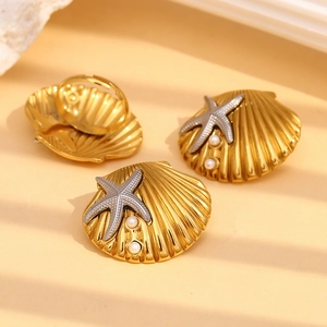 18K gold plated shell ring and earrings with starfish and pearls on warm background