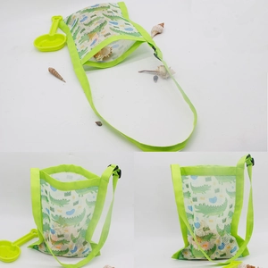Detail view of green mesh beach bag with crocodile print and adjustable strap for kids