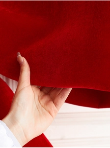 Detail showing the thick texture of premium red velvet fabric for oversized Christmas bows
