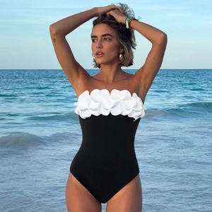 Sleek black monokini with white 3D floral petals on tube top bodice for summer beach