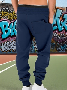 Rear view of men's navy jogger pants featuring elastic cuffs and a back patch pocket